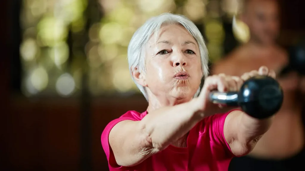 Toning Bingo Wings: Effective Exercises and Tips for Achieving Sleeker Arms 2 Person performing arm exercises with dumbbells Littlehampton