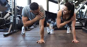 Image of man and woman doing Cardio Littlehampton to tone their arms. 